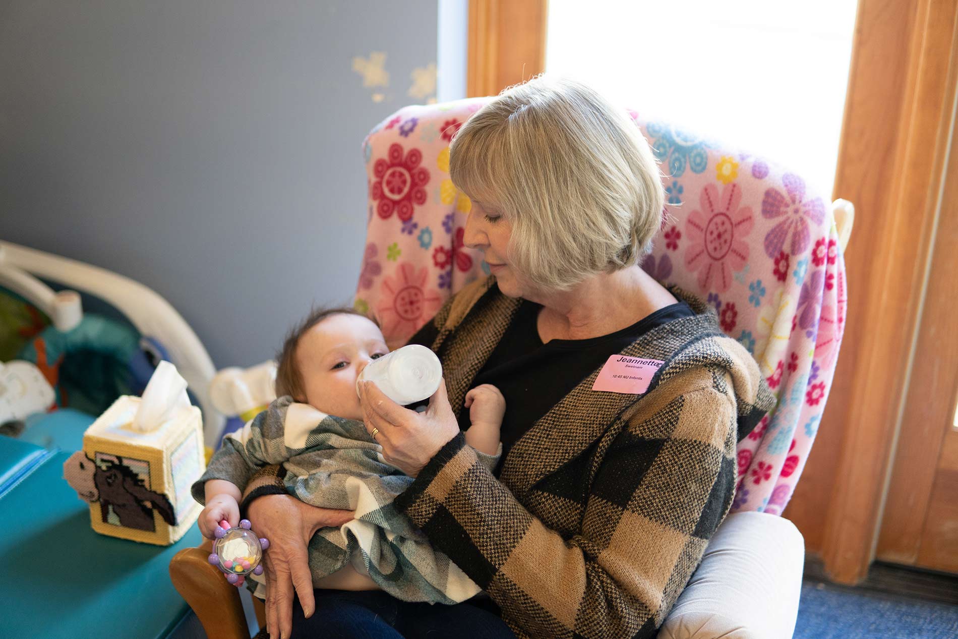 Woman feeding baby with bottle