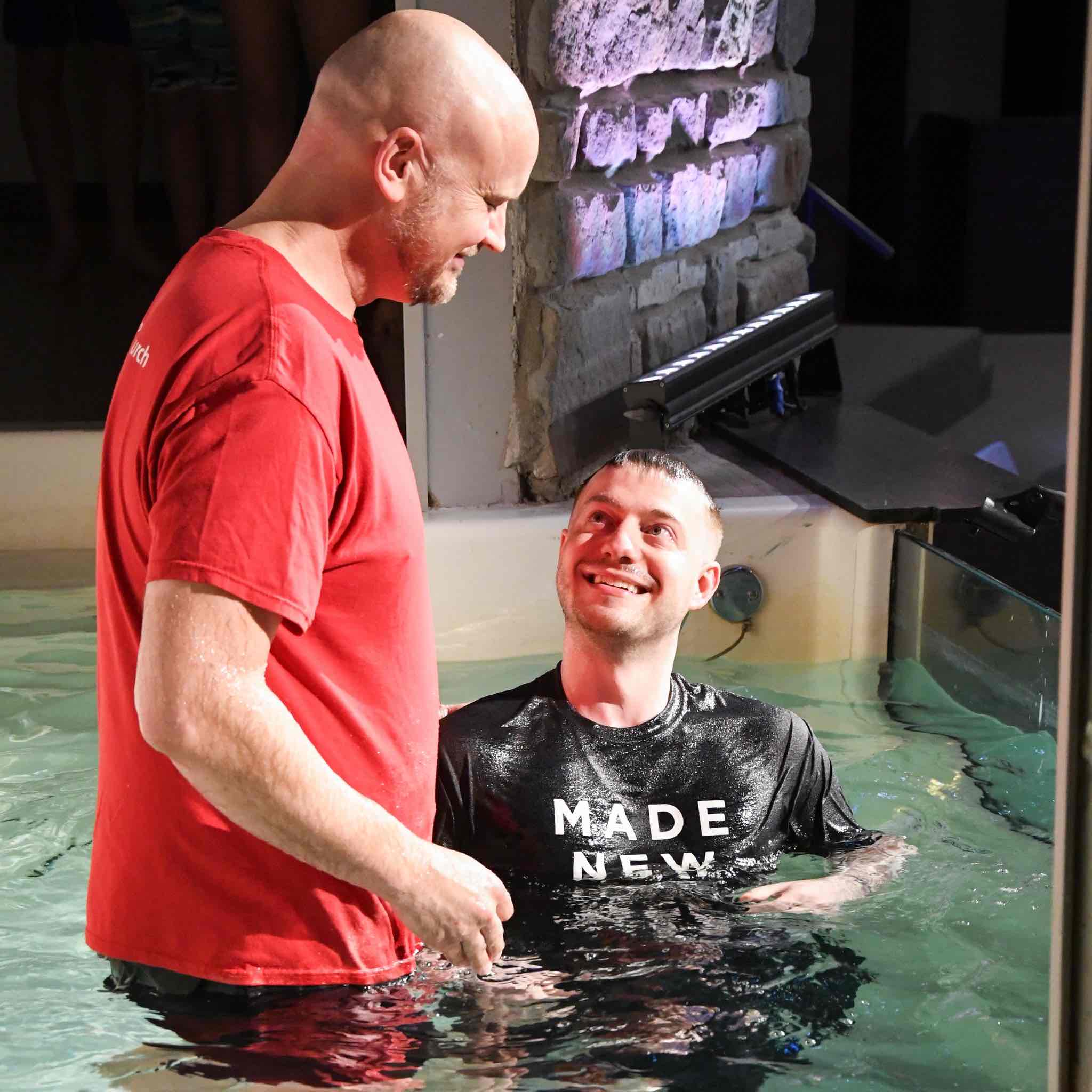 Pastor baptizing a man