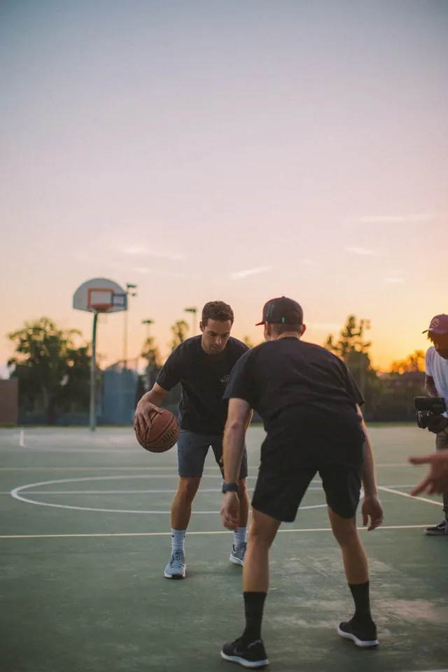 Two men playing basketball