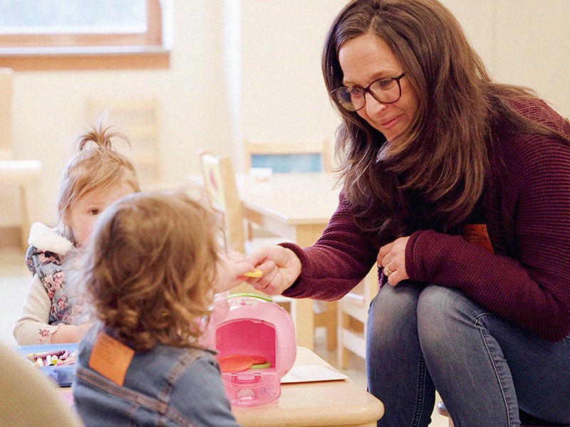 Woman teaching toddlers