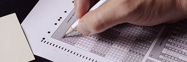Person filling in answer on test