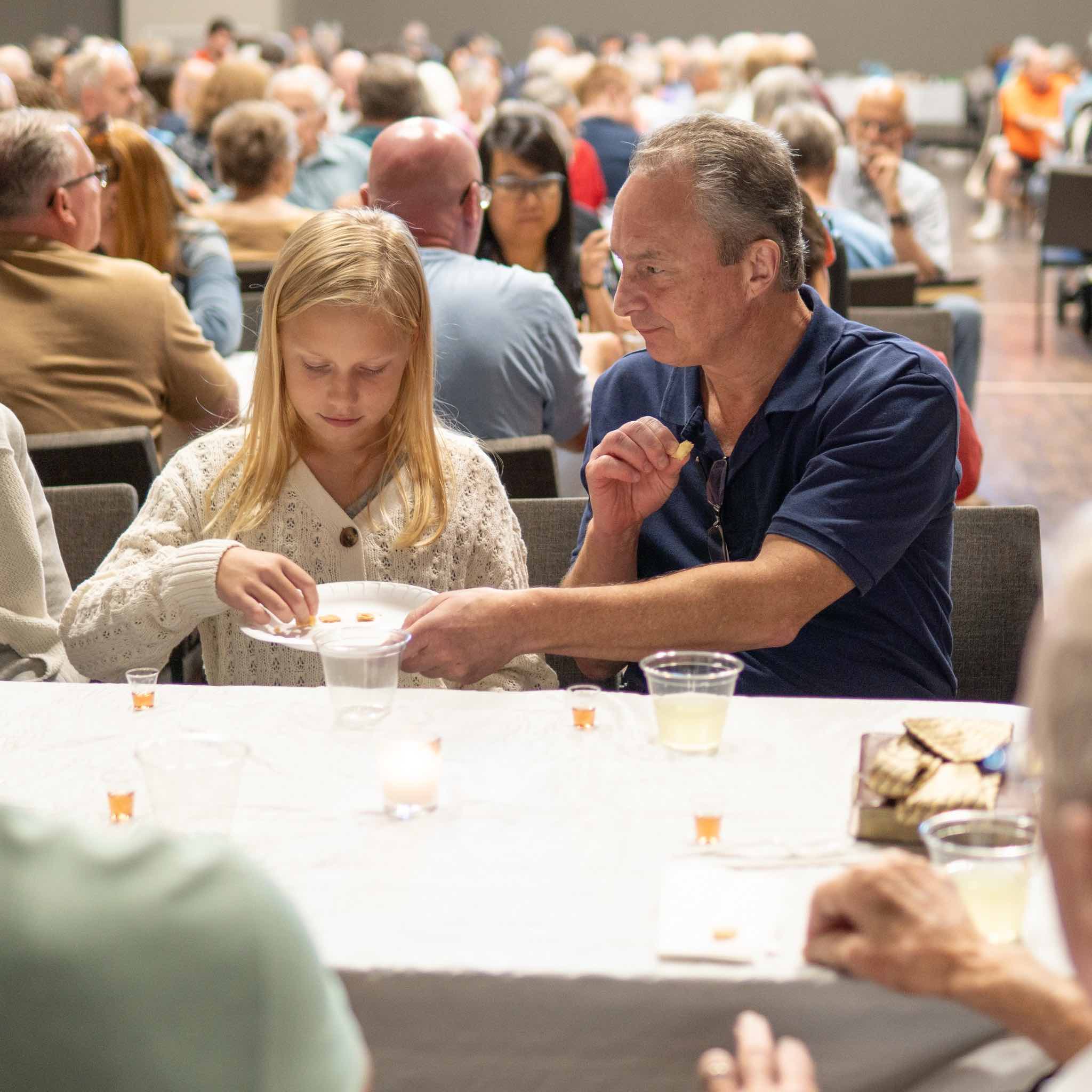 communion Man serving girl communion bread